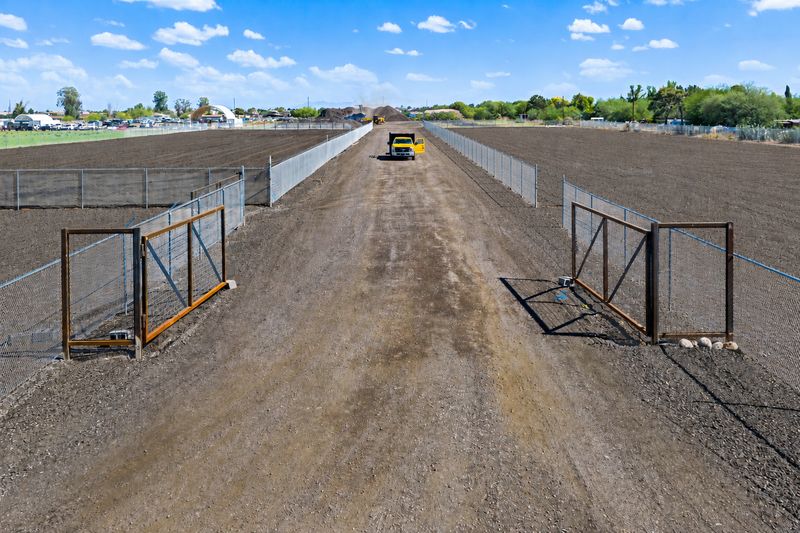 Drive-aisle entry through the south gate at Gilbert Yards